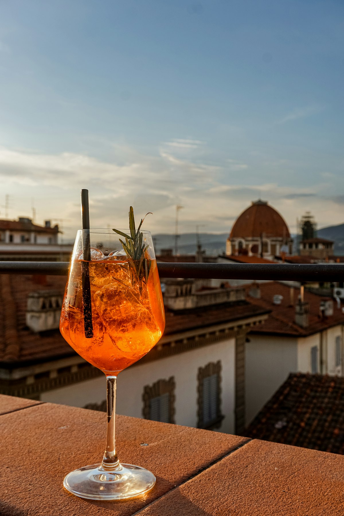 Cocktail overlooking rooftops from a terrace (illustrative photo)