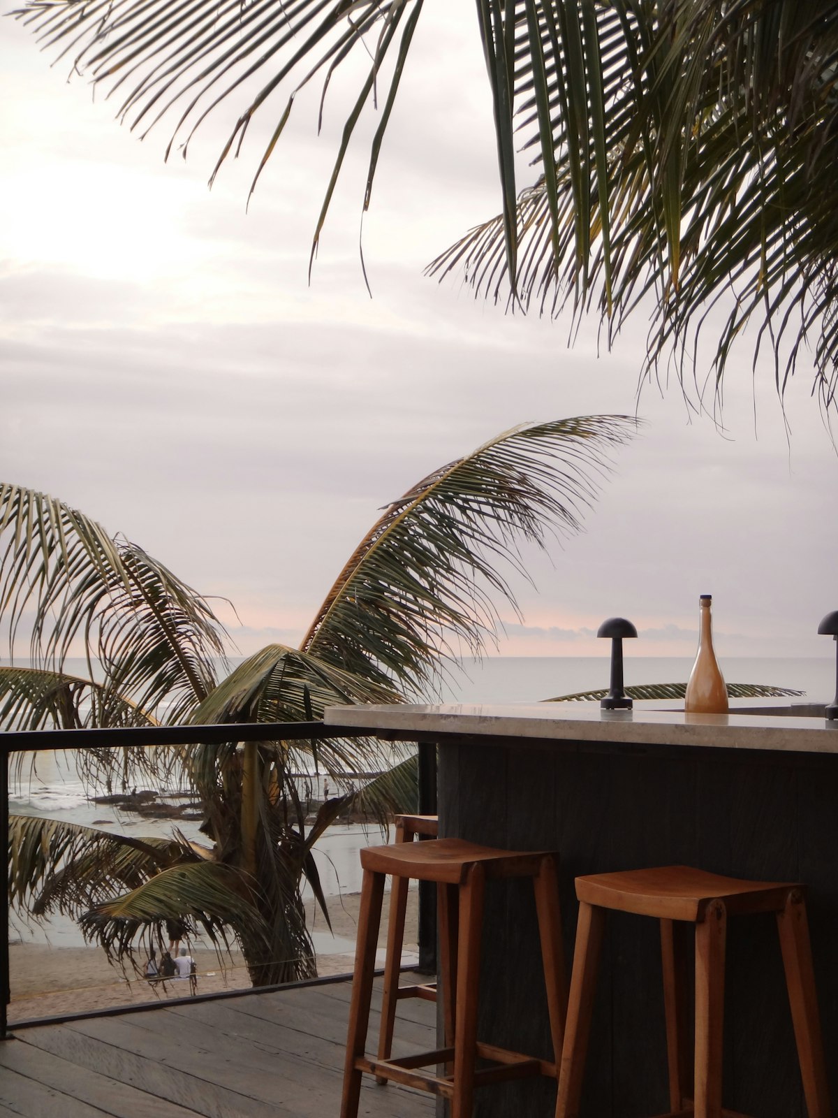 Open-air bar overlooking the ocean at sunset (illustrative photo)