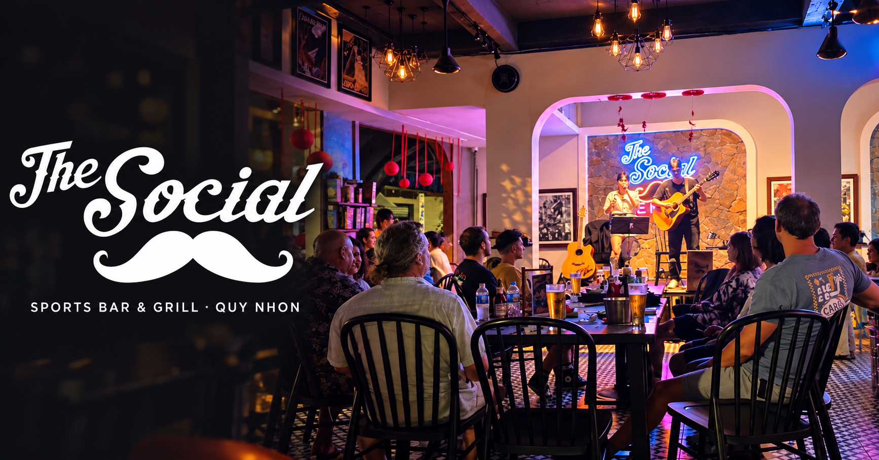 Guests enjoying live music inside The Social Sports Bar & Grill in Quy Nhon